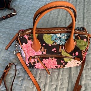 Dooney and Bourne Hydrangea barrel bag with crossbody-length strap.